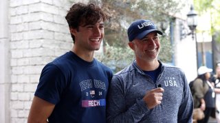 Paralympian Ezra Frech of Los Angeles, California, and his father Clayton Frech get interviewed at a Parisian cafe during the Team USA Road to Paris Bus Tour on November 15, 2023 in Los Angeles, California.