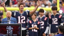 FOXBOROUGH, MASSACHUSETTS - SEPTEMBER 10: New England Patriots owner Robert Kraft speaks while former New England Patriots quarterback Tom Brady reacts while Brady's children, Vivian, Benjamin, and Jack, look on during a ceremony honoring Brady at halftime of New England's game against the Philadelphia Eagles at Gillette Stadium on September 10, 2023 in Foxborough, Massachusetts. (Photo by Maddie Meyer/Getty Images)