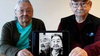 Pauline Golodoff, left, and George Kudrin hold an iPad featuring images of their deceased spouses, Gregory Golodoff and Elizabeth Golodoff Kurdrin,