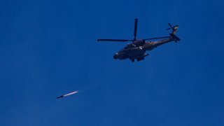 An Israeli Apache helicopter fires a missile in direction of the Gaza Strip.