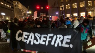 FILE. Protesters calling for an Israeli ceasefire in Gaza block an intersection in Boston, Thursday, Dec. 14, 2023.