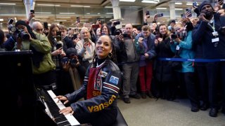 Alicia Keys performs on the Sir Elton John piano at St Pancras International Station