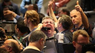 Traders signal offers in the Standard & Poor’s 500 stock index options pit at the Chicago Board Options Exchange (CBOE).