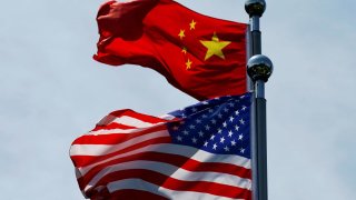 Chinese and U.S. flags flutter near The Bund, before U.S. trade delegation meet their Chinese counterparts for talks in Shanghai, China July 30, 2019.