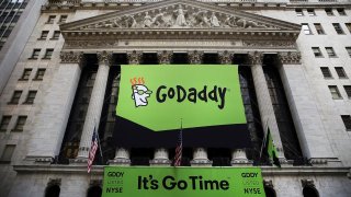 The GoDaddy banner hangs outside of the New York Stock Exchange as the website hosting service makes its initial public offering on April 1, 2015.