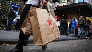A customer exits the Macy’s flagship department store in midtown Manhattan in New York City, U.S., December 11, 2023. 