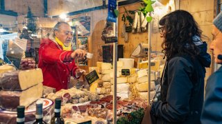 Shoppers at delicatessen market stall in Milan, Italy, on Thursday, Dec. 28, 2023.