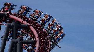Guests ride a rollercoaster at Six Flags Magic Mountain theme park in Valencia, California, US, on Saturday, Nov. 4, 2023.