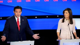 Former UN Ambassador Nikki Haley, right, looks over toward Florida Gov. Ron DeSantis, left, during the CNN Republican presidential debate at Drake University in Des Moines, Iowa, Wednesday, Jan. 10, 2024.