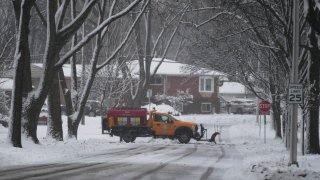 A snow plow cleans the road