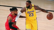 Aug 20, 2020; Lake Buena Vista, Florida, USA; Los Angeles Lakers forward LeBron James (23) controls the ball against Portland Trail Blazers guard Gary Trent Jr. (left) during the first half of a NBA basketball first round playoff game in the 2020 NBA playoffs at AdventHealth Arena. Mandatory Credit: Kim Klement-USA TODAY Sports