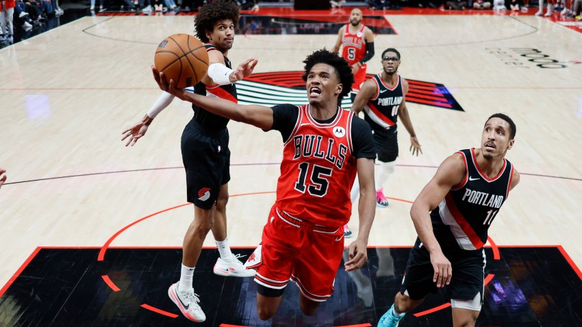 Jan 28, 2024; Portland, Oregon, USA; Chicago Bulls forward Julian Phillips (15) shoots the ball past Portland Trail Blazers point guard Malcolm Brogdon (11) during the second half at Moda Center. Mandatory Credit: Soobum Im-USA TODAY Sports