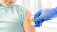 Vaccination of little girl in doctor’s office.Kids funny adhesive plaster,gauze napkin.Hand in glove.Vaccine for covid-19 coronavirus,flu,infectious diseases.Injection.Clinical trials for human,child.