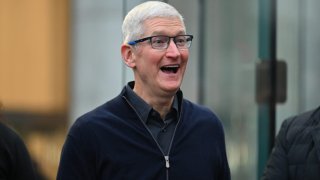 Apple CEO Tim Cook (2nd R) greets customers as he arrives for the release of the Vision Pro headset at the Apple Store in New York City on February 2, 2024.