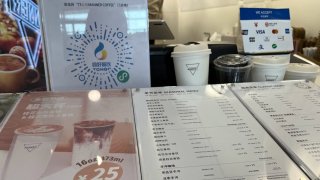 A coffee shop at Beijing Capital Airport shows customers can use Visa, Mastercard, the digital Chinese yuan and other payment methods.