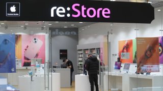 People stand in a “re:store,” an Apple resale store in a shopping center in St. Petersburg. Apple has suspended sales of its products in Russia because of Russia’s war of aggression against Ukraine.