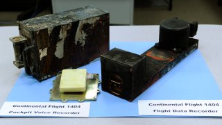 The cockpit voice recorder, left, and the flight data recorder from Continental flight 1404 airplane accident on display at the National Transportation Safety Board headquarters in Washington, Dec. 22, 2008.