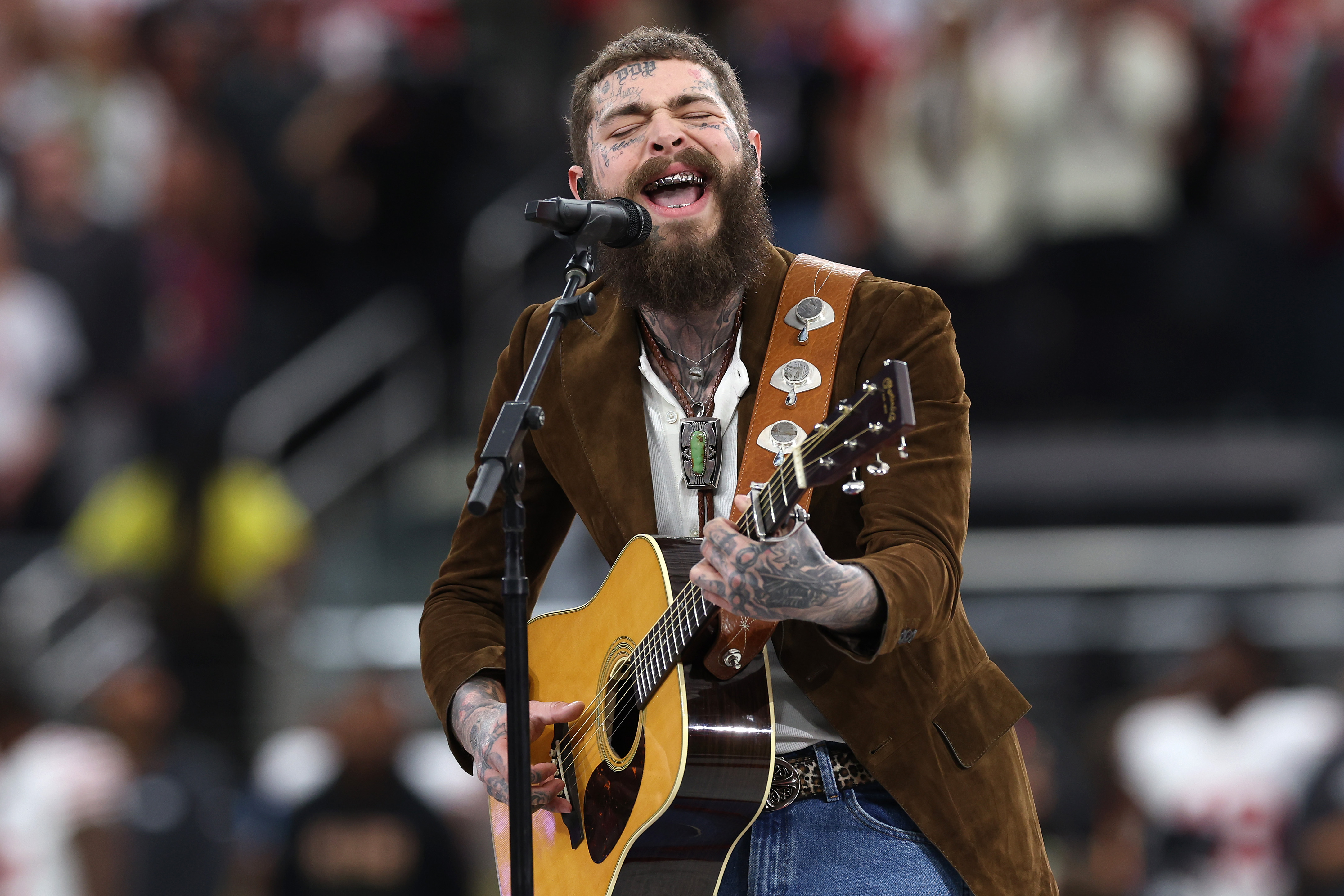 American rapper and singer Post Malone performs prior to Super Bowl LVIII between the San Francisco 49ers and Kansas City Chiefs at Allegiant Stadium on February 11, 2024 in Las Vegas, Nevada.<br><em>(Photo by Jamie Squire/Getty Images)</em>