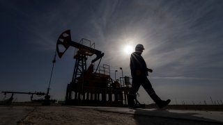 An oil and gas industry worker walks during operations of a drilling rig at Zhetybay field in the Mangystau region, Kazakhstan, November 13, 2023. 