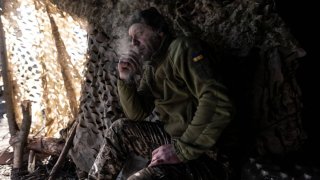 A Ukrainian soldier is seen at the entrance to a shelter in his fighting position in the direction of Kupiansk, Kharkiv Oblast, Ukraine on March 12, 2024.