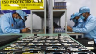 Workers assembles smartphones at Dixon Technologies factory in Uttar Pradesh, India, on Thursday, Jan. 28, 2021. 