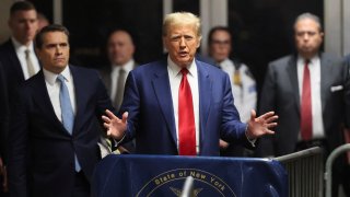 Former U.S. President Donald Trump speaks from the hallway outside a courtroom where he attended a hearing in his criminal case on charges stemming from hush money paid to a porn star in New York City, U.S., March 25, 2024. 