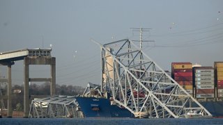 The collapsed Francis Scott Key Bridge lies on top of the container ship Dali in Baltimore, Maryland, on March 29, 2024. 