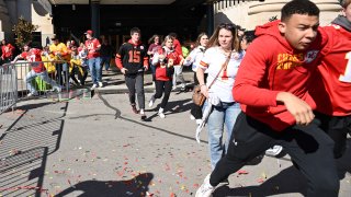 People flee after shots were fired near the Kansas City Chiefs’ Super Bowl LVIII victory parade on February 14, 2024, in Kansas City, Missouri.