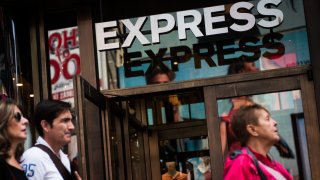 Pedestrians walk past an Express Inc. store in New York, U.S., on Wednesday, May 31, 2017.