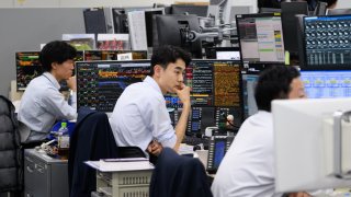 Employees work in the trading room inside the Mitsubishi UFJ Trust and Banking head office in Tokyo, Japan, on Tuesday, March 19, 2024.