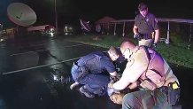 In this image from Altoona Police Department body-camera video, police restrain Demetrio Jackson in a parking lot on the border of Altoona and Eau Claire, Wis., on Oct. 8, 2021, minutes before a paramedic injects him with ketamine. Five medical experts who reviewed the case for AP said Jackson’s behavior did not appear to be dangerous enough to justify the use of ketamine. (Altoona Police Department via AP)