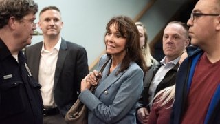 Diane Hendricks enters the room where Blackwater founder Erik Prince was supposed to speak before the event was disrupted by protesting students Wednesday, March 27, 2019, at Beloit College in Beloit, Wis.