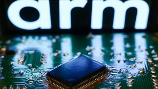 Arm logo displayed on a screen and and microchip are seen in this illustration photo taken in Krakow, Poland on September 14, 2023.