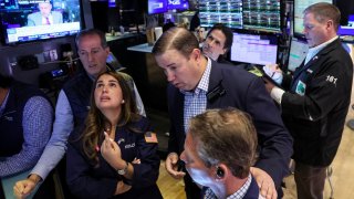 Traders work on the floor at the New York Stock Exchange.