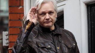 LONDON, ENGLAND – MAY 19: Julian Assange gestures as he speaks to the media from the balcony of the Embassy Of Ecuador on May 19, 2017 in London, England. Photo by Jack Taylor/Getty Images)