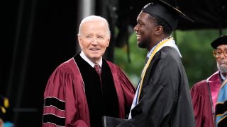 President Joe Biden, left, stands with valedictorian DeAngelo Jeremiah Fletcher at the Morehouse College commencement Sunday, May 19, 2024, in Atlanta.