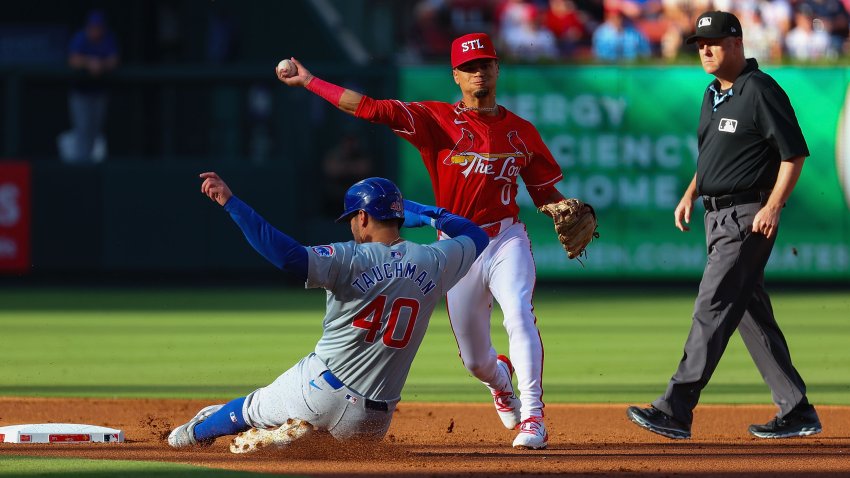 ST LOUIS, MISSOURI – MAY 25: Masyn Winn #0 of the St. Louis Cardinals turns a double play over Mike Tauchman #40 of the Chicago Cubs in the first inning at Busch Stadium on May 25, 2024 in St Louis, Missouri. (Photo by Dilip Vishwanat/Getty Images)