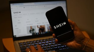 The Shein logo can be seen on a smartphone, while the Chinese online retailer’s website is open on a laptop.