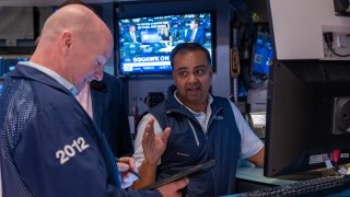 Traders work on the floor of the New York Stock Exchange on June 18, 2024.