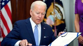 President Biden signs a bill into law.