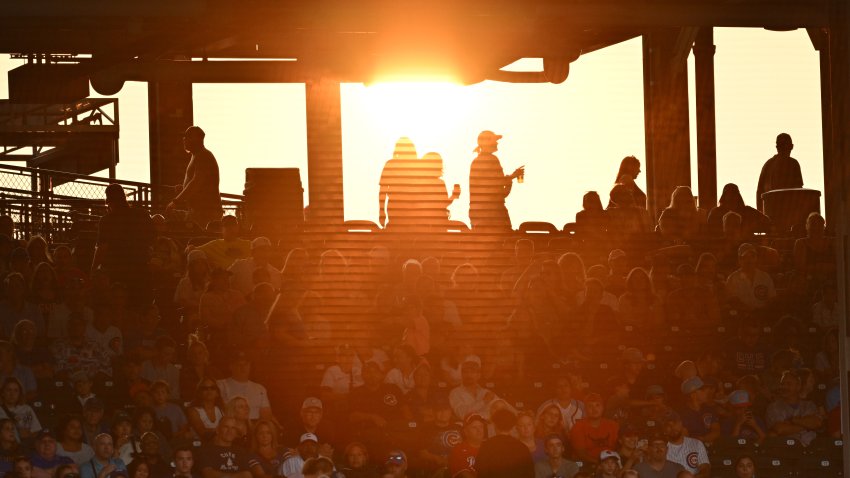CHICAGO, IL – JULY 31:  Fans watch the Chicago Cubs play the Cincinnati Reds as the sun sets at Wrigley Field on July 31, 2023 in Chicago, Illinois.  (Photo by Jamie Sabau/Getty Images)
