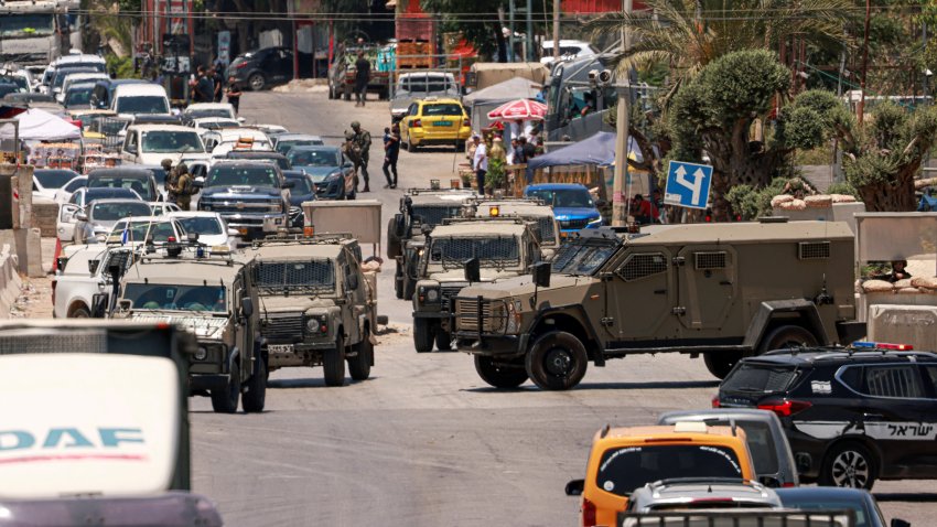 Israeli army vehicles close off the entrance to the West Bank city of Qalqilya after an Israeli civilian was shot and killed on June 22, 2024, amid the ongoing conflict between Israel and the Palestinian Hamas militant group in the Gaza Strip. The Israeli military said on June 22, that an Israeli civilian died after being shot near the Israeli occupied West Bank city of Qalqilya and that troops had launched an operation in the area. Violence in the West Bank, occupied by Israel since 1967, has been on the rise for more than a year, particularly since the Israel-Hamas war broke out on October 7.