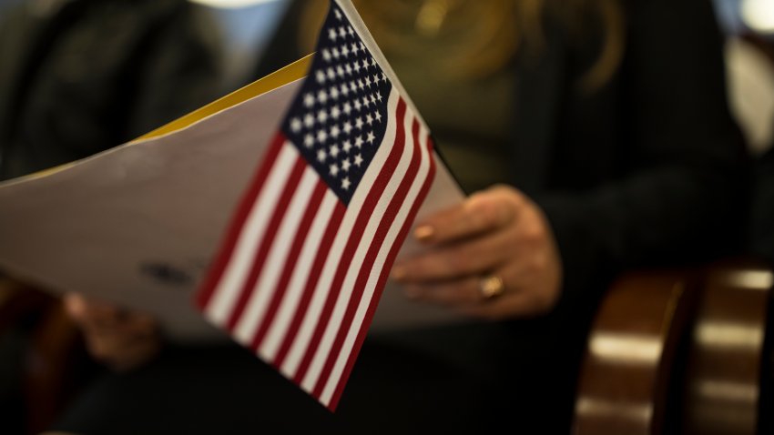 NEWARK, NEW JERSEY – FEBRUARY 16: A newly sworn in US citizen holds a US flag while listening to a speech from a US government employee at a naturalization ceremony for new US citizens February 16, 2017 in Newark, New Jersey. Eighty-nine applicants from thirty-seven countries received their certificates of citizenship. (Photo by Robert Nickelsberg/Getty Images)