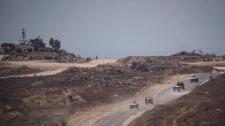 Israeli soldiers move near the Israeli-Gaza border as seen from southern Israel, Monday, June 10, 2024.