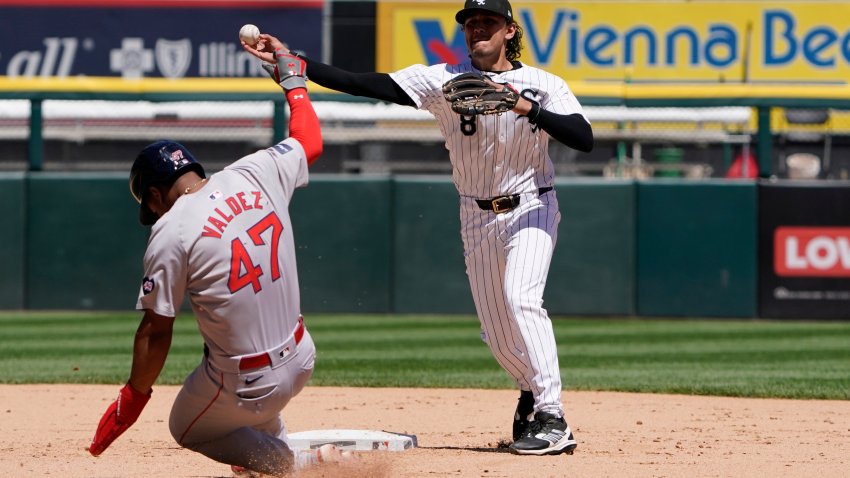 Jun 9, 2024; Chicago, Illinois, USA; Chicago White Sox second base Nicky Lopez (8) forces out Boston Red Sox second baseman Enmanuel Valdez (47) at second base during the fourth inning at Guaranteed Rate Field. Mandatory Credit: David Banks-USA TODAY Sports