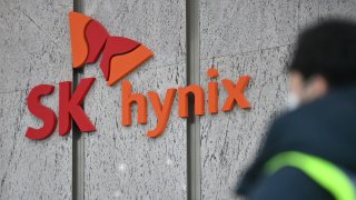 A man walks past a logo of SK Hynix at the lobby of the company’s Bundang office in Seongnam on January 29, 2021.