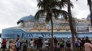 Onlookers gather at South Pointe Park to watch Royal Caribbean’s “Icon of the Seas”, the world’s largest cruise ship, as it sails from Port Miami on its maiden cruise, in Miami Beach, Florida on January 27, 2024.