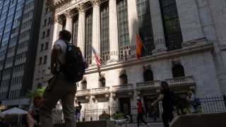 People walk by the New York Stock Exchange (NYSE) on June 18, 2024 in New York City. 