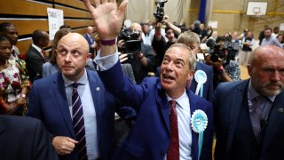 Reform UK leader Nigel Farage waves after being elected to become MP for Clacton at the Clacton count centre in Clacton-on-Sea, eastern England, early on July 5, 2024. 