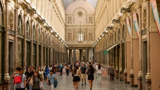 Shoppers make their way through the Royal Saint-Hubert Galleries shopping arcade in the old town area of Brussels, Belgium, on Friday, June 28, 2024.